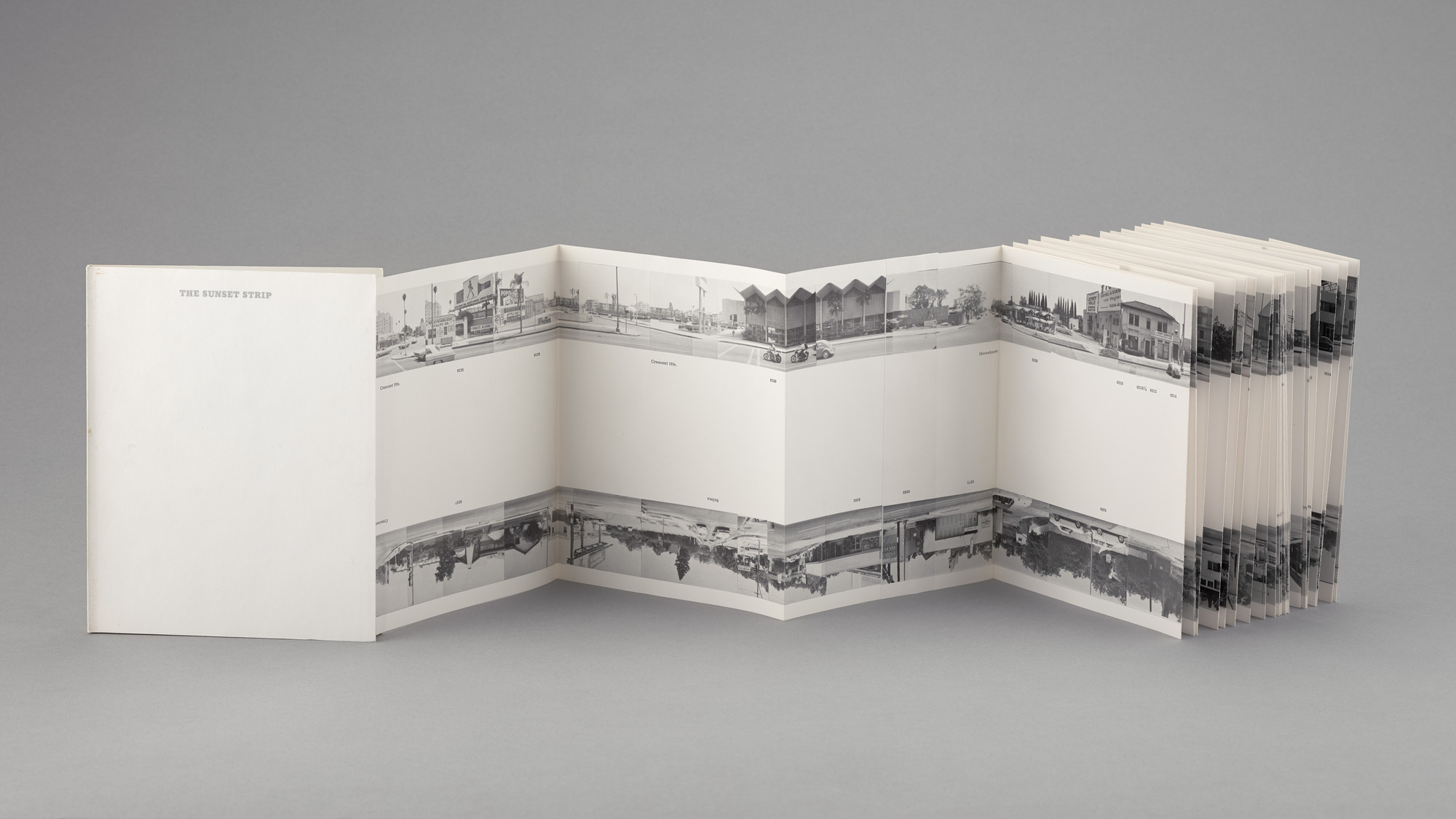 Ed Ruscha, Every Building on the Sunset Strip, 1966 — the 27-foot accordion-fold artist’s book, north side above, south side mirrored below. The Museum of Modern Art.